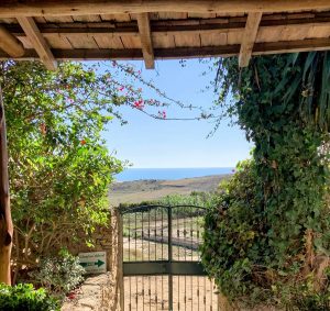 view from front door of moroccan cottage across gate to the sea