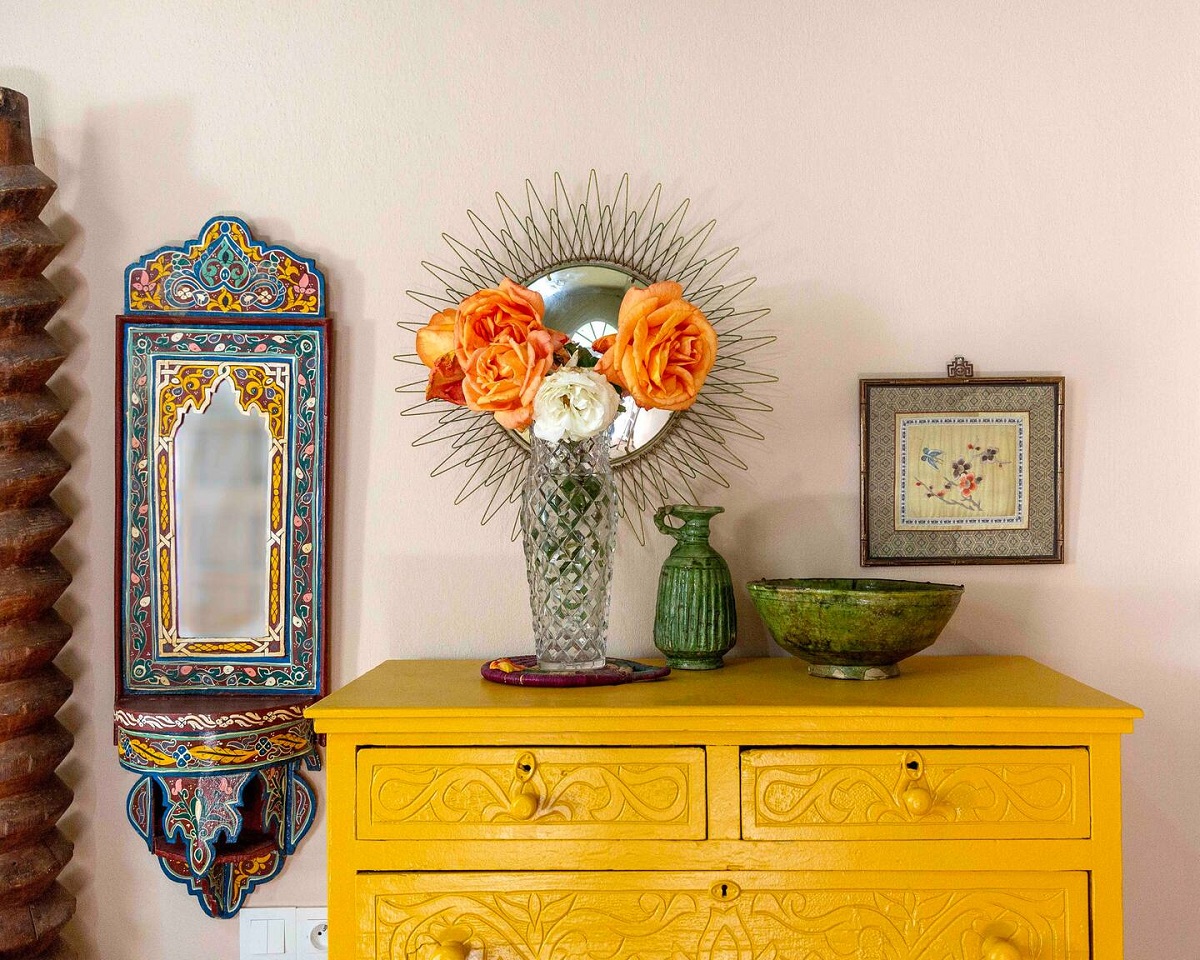 yellow chest of drawers, peach roses, moroccan mirror